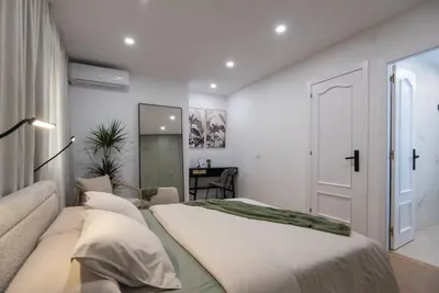 a bedroom with a large bed and a couch at +25Y ONLY, Family flat near the beach in Barcelona