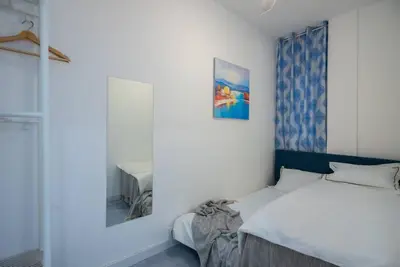 a bedroom with a bed and a picture on the wall at +25Y ONLY, Family flat near the beach in Barcelona