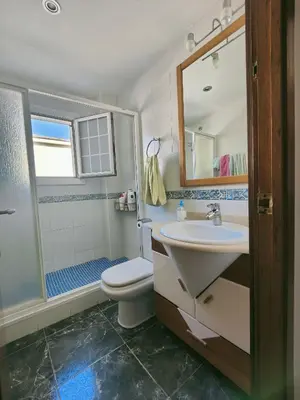 a bathroom with a sink and a toilet and a mirror at Apartamento en la playa in Cunit