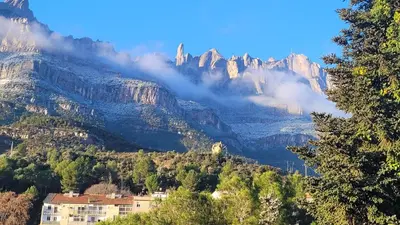 a bedroom with a window with a view of mountains at Apartamento en Montserrat- Montserrat Paradise Apartament in Monistrol