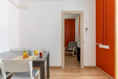 a dining room with a table and chairs at AB Vila i Vila Apartments in Barcelona