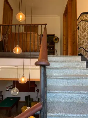 a set of stairs with pendant lights at Ca l'Andreu Teià. Casa modernista in Teià