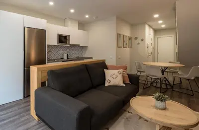 a living room with a couch and a table at CATERINA Mar Bella in Barcelona