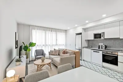a kitchen and living room with a couch and a table at CATERINA Mar Bella in Barcelona