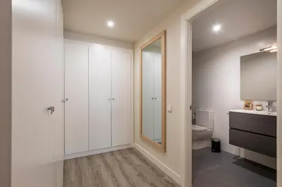 a bathroom with a toilet and a sink and a mirror at CATERINA Mar Bella in Barcelona