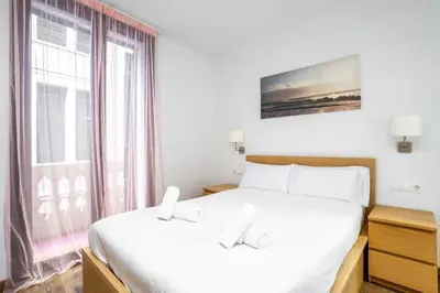 a white bedroom with a bed and a sink at The Collection Barcelona - Paseo de Gracia Modern and cozy 3BD - 2BTh in Barcelona
