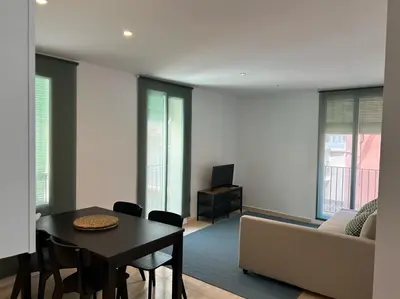 a living room with a table and a couch at Gaudi(M) Barcelona in Barcelona