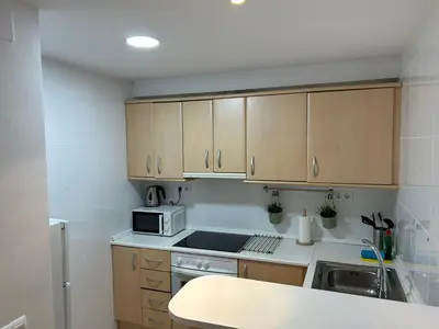 a kitchen with wooden cabinets and a microwave at Gaudi(M) Barcelona in Barcelona