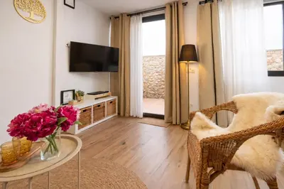 a kitchen with white cabinets and a stove top oven at Private Loft Sant Celoni, Montseny, Barcelona in San Celoni