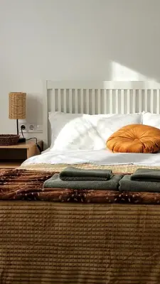 a bed with three pillows on top of it at Apartament a Sant Celoni, Montseny, Barcelona in San Celoni