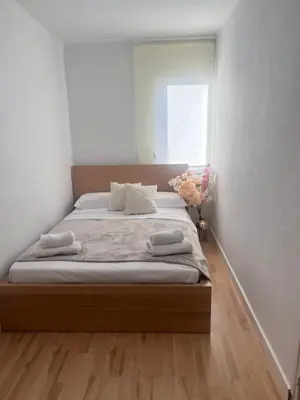 a bedroom with a bed with two towels on it at Ca La Lidia in Viladecáns
