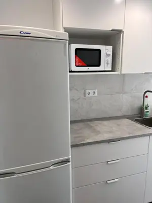 a kitchen with a white refrigerator and a microwave at Ca La Lidia in Viladecáns
