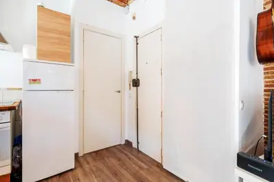 a kitchen with white walls and two doors at Beachside Bliss Charming 1-bedroom, Barceloneta in Barcelona