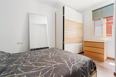 a bedroom with a bed and a window at Beachside Bliss Charming 1-bedroom, Barceloneta in Barcelona