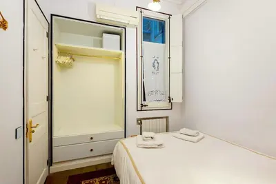 a white bedroom with a bed and a mirror at Large patio 4 bedrooms 4 bathrooms of which 3 en-suite in Barcelona