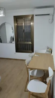 a table and chairs in a room with a mirror at metro La Salut in Badalona