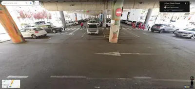 a parking lot with cars parked in a parking garage at metro La Salut in Badalona