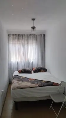 a bedroom with a large bed with a window at metro La Salut in Badalona