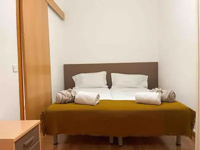 a bed with two pillows on it in a room at Hostourist@Bcn Apartamento Monumental in Barcelona