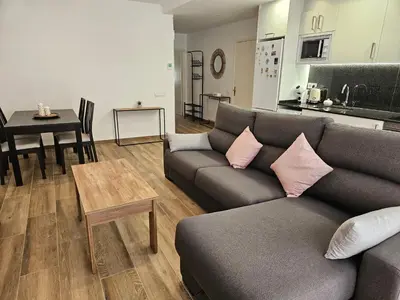 a living room with a couch and a table at Apartament LA SAL in Pineda de Mar