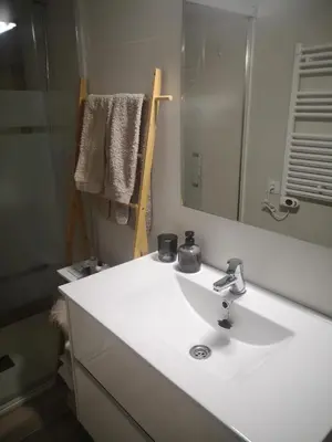 a bathroom with a white sink and a mirror at Apartament LA SAL in Pineda de Mar