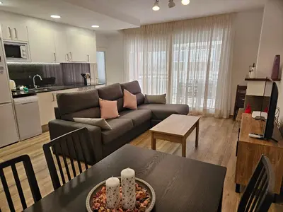 a living room with a couch and a table at Apartament LA SAL in Pineda de Mar