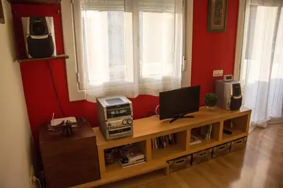 a living room with a television and a computer on a table at A Home in Barcelona in Barcelona