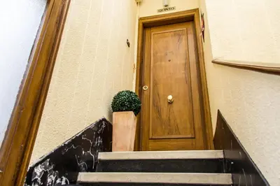 a stairway leading to a door with a potted plant at A Home in Barcelona in Barcelona
