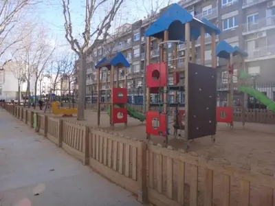 a playground with slides and play equipment in front of a building at A Home in Barcelona in Barcelona