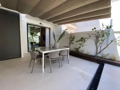 a white table and chairs on a patio at Sitges Spaces Garden Oasis 3 Bedroom 2 Bath Garden in Sitges