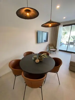 a dining room with a black table and chairs at Sitges Spaces Garden Oasis 3 Bedroom 2 Bath Garden in Sitges