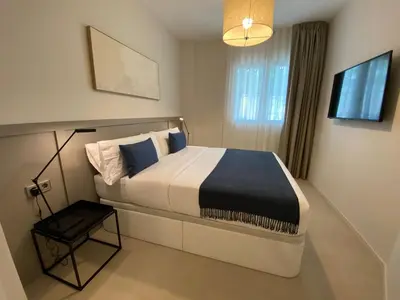 a bedroom with a bed and a television in it at Sitges Spaces Garden Oasis 3 Bedroom 2 Bath Garden in Sitges