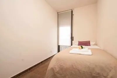 a bedroom with a bed with a flower on it at Port IV Apart céntrico ideal grupos 12 in Barcelona