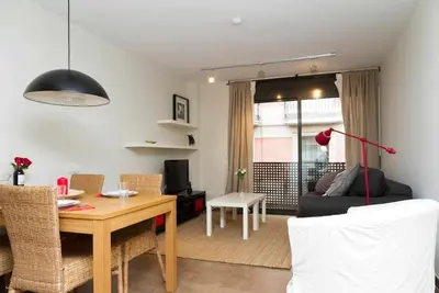 a living room with a table and a living room with a couch at Port VI Apart céntrico ideal familias 22 in Barcelona