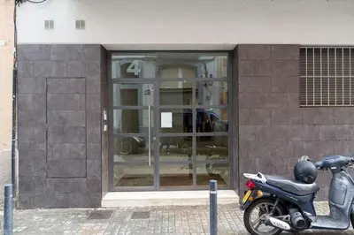 a motor scooter parked in front of a building at Port VI Apart céntrico ideal familias 22 in Barcelona