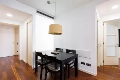 a dining room with a black table and chairs at Ola Living Plaza Catalunya in Barcelona
