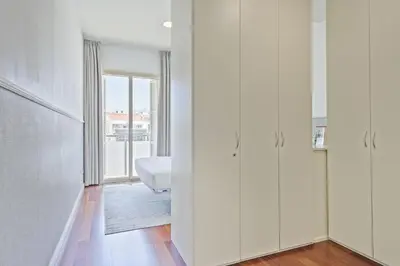 a room with white cabinets and a bedroom with a window at Ola Living Plaza Catalunya in Barcelona