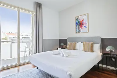 a bedroom with a large white bed and a large window at Ola Living Plaza Catalunya in Barcelona