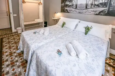 a bedroom with a bed with towels and flowers on it at Casa del Mediterraneo in Barcelona