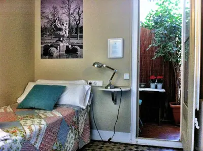 a bedroom with a bed with a lamp on it at Casa del Mediterraneo in Barcelona
