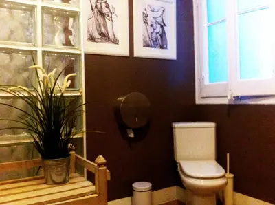 a bathroom with a toilet and some drawings on the wall at Casa del Mediterraneo in Barcelona
