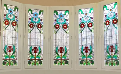 a group of stained glass windows in a room at Casa del Mediterraneo in Barcelona