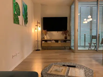 a living room with a flat screen tv and a couch at Forum Casa Barcelona in Sant Adria de Besos