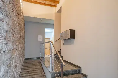 a staircase in a building with a brick wall at GuestReady - Bright home near Montjuïc in Barcelona