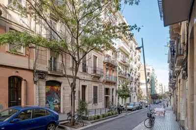 a blue car parked on a city street with buildings at GuestReady - Bright home near Montjuïc in Barcelona