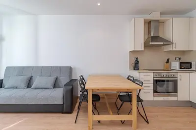 a living room with a table and a couch at GuestReady - Bright home near Montjuïc in Barcelona