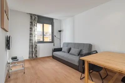 a living room with a couch and a table at GuestReady - Bright home near Montjuïc in Barcelona