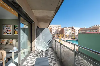 a balcony with a chair and a swimming pool at CATERINA Sagrera in Barcelona