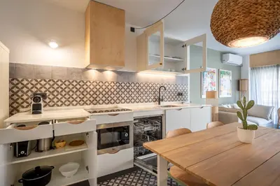 a kitchen with a wooden table and a dining room at CATERINA Sagrera in Barcelona
