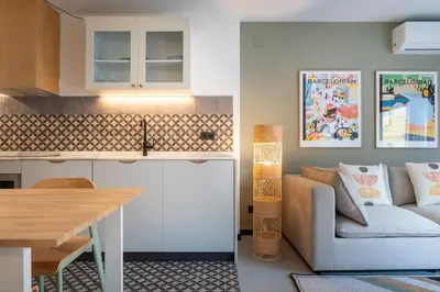 a kitchen and living room with a couch and a table at CATERINA Sagrera in Barcelona